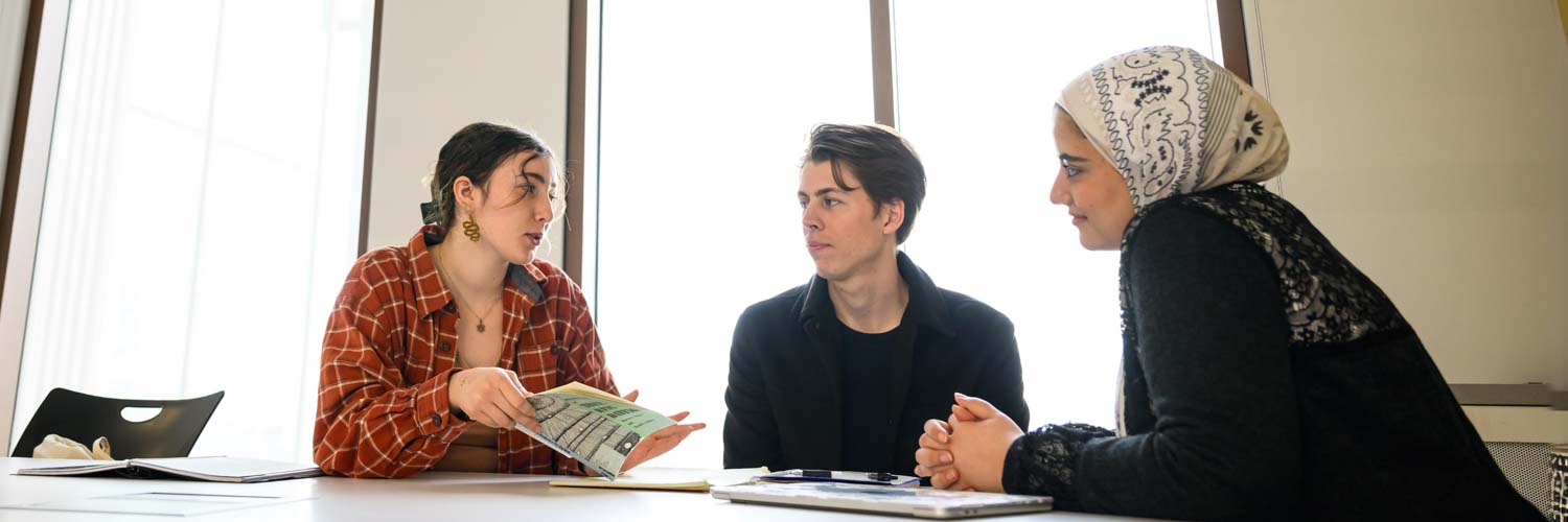 three students studying together